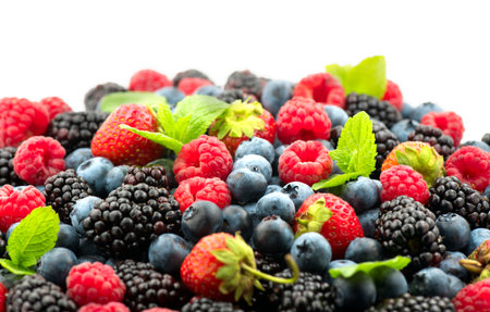 Berries. Various colorful berries background. Mint leaves, Strawberry, Raspberry, Blackberry, Blueberry close-up backdrop, isolated on whiteの写真素材