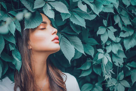 Beautiful fashion model girl enjoying nature, breathing fresh air in summerの写真素材