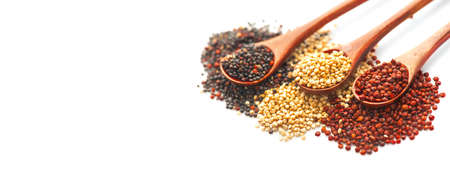 Black, red and white quinoa grains in a wooden spoon isolated on white background. Gluten free Healthy food. Seeds of white, red and black quinoa - Chenopodium quinoa closeup.の写真素材