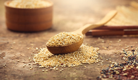 Quinoa White grains in a wooden bowl and spoon. Gluten free Healthy food. Diet, dieting concept. Seeds of white quinoa - Chenopodium quinoa.の写真素材