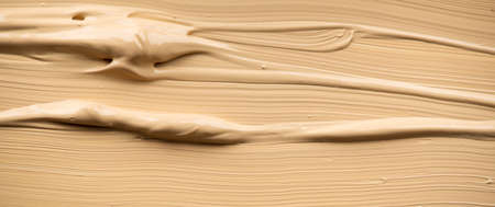 Foundation, concealer, face makeup smudge, smears. Cosmetic liquid foundation or cream beige color smudges, stroke. Contouring, Make up smears background. Foundation texture surfaceの写真素材