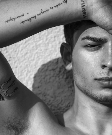 Young man fashion portrait. Handsome male close up. Black and white portrait of sexy muscular guy,...