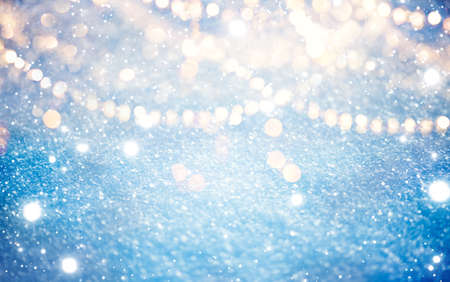 Snow background, glowing winter backdrop with garlands. Christmas lights, nature. White cold waves of snow sparkles. Glitter Xmas abstract wallpaper, frameの写真素材