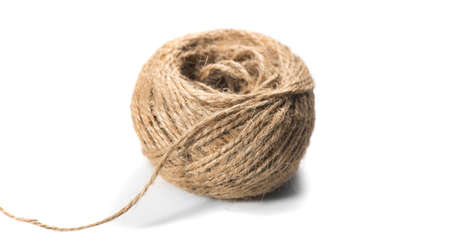 Coil of natural jute rope isolated on white background. Packaging cord roll, craft, eco-friendly natural rope coil. tangled thread. Hank of Twineの写真素材