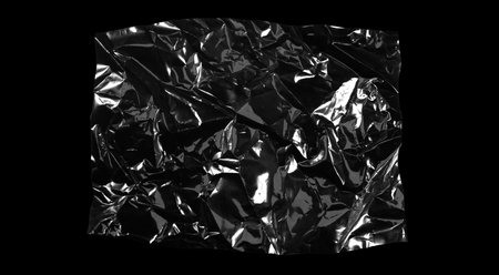 Transparencies. Transparent plastic film texture isolated on black backgroundの写真素材