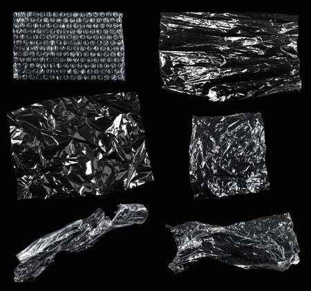 Transparencies. Transparent plastic film texture isolated on black background. Set of plastic packaging materials texturesの写真素材