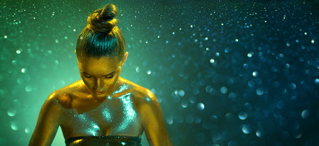 Fashion art portrait. Model girl in colorful bright sparkles, gold and green skin, neon lights ...
