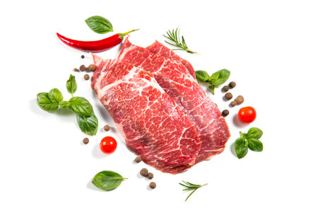 Raw meat isolated on white background. Prime fillet meat. Marble beef steak Black Angus Steak Rib eye served witj spices. Top viewの写真素材