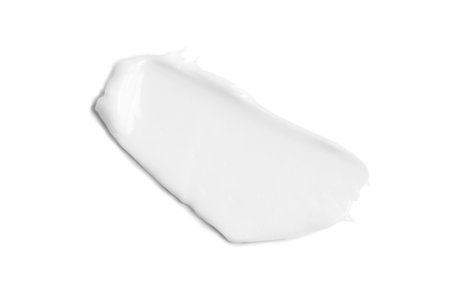 White cream smear, isolated on white background. Moisturizer, facial, hands or body cream, beauty product texture, smudge.の写真素材