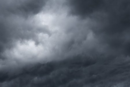 Dark clouds sky background. Dramatic dark storm rain clouds, black sky backdrop. Dark thunderstorm clouds, rainy atmosphere. Meteorology danger windstorm disasters climate. Dark clの写真素材
