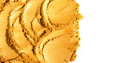Gold powder isolated on white background. Golden metallic dry paint border design, closeup. Cosmetic, shimmer, art paint. Texture of gold metal powder close upの写真素材