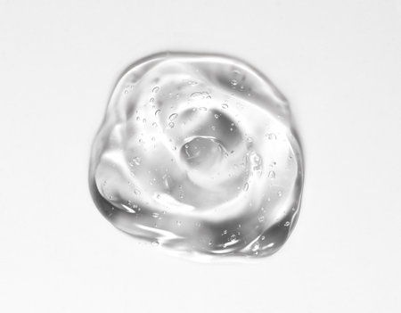 Transparent gel drop. Liquid cream gel cosmetic smudge texture on white background. Cosmetics serum gel, hyaluronic acid cream background, gelly facial treatment, fluidの写真素材