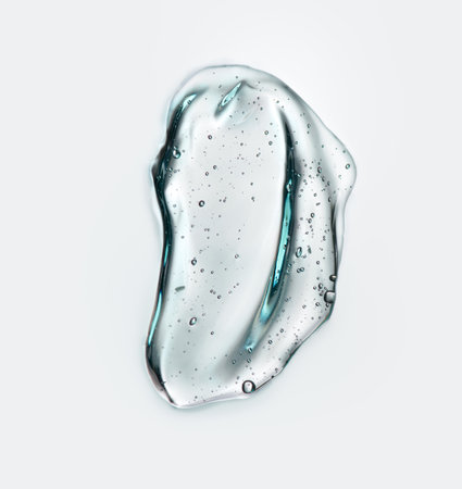 Transparent gel drop. Liquid cream gel cosmetic smudge texture on white background. Cosmetics serum gel, hyaluronic acid cream background, gelly facial treatment, fluidの写真素材