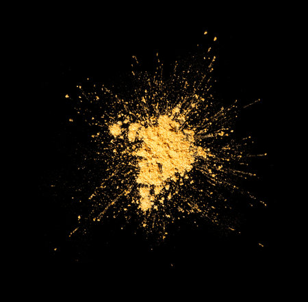 Gold powder explosion, splash isolated on black background, top view. Explosion of golden sand. Cosmetics, eye shadowsの写真素材