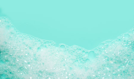 Foam texture close up. Soap foam bubbles background. Soap sud macro structure, close-up, blue backgroundの写真素材