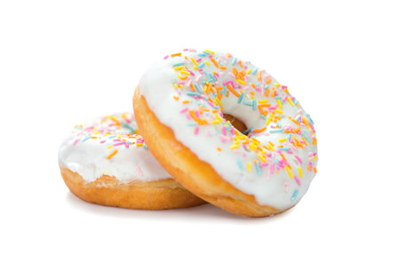 Donuts close up. Two Sweet Tasty colorful glazed donuts closeup. Doughnut isolated on white backgroundの写真素材