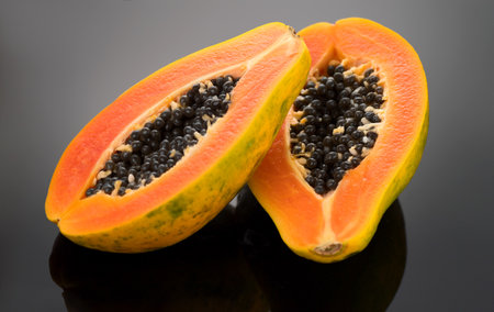 Papaya fruit on black background. Fresh organic Papaya exotic fruits close up. Healthy vegan papayasの写真素材