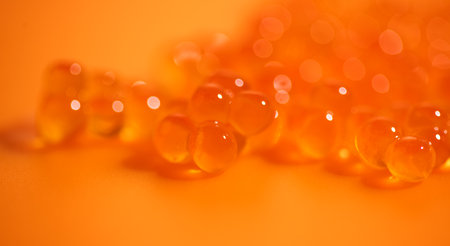 Red Caviar macro shot, Caviar over orange background. Fish roe, Close-up salmon or trout caviar. Delicatessen. Gourmet food. Texture of caviar. Seafood.の写真素材