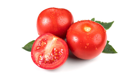Tomato. Fresh Ripe natural tomatoes close-up. Organic tomato with leaves isolated on white background. Macro shot. Garden, Gardening concept. Ketchup, pasta, sauce ingredientの写真素材