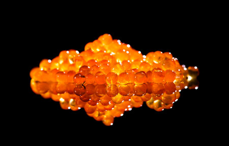 Red caviar close up. Salmon caviar isolated on black background. Delicious gourmet food.  Delicatessen. Texture of caviar. Seafood, macro shot.の写真素材