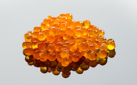 Red caviar close up. Salmon caviar rotating over gray background. Delicious gourmet food.  Delicatessen. Texture of caviar. Seafood, macro shot.の写真素材