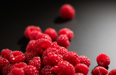 Raspberry fresh berries closeup, ripe fresh organic Raspberries over black background, macro shot. Harvest conceptの写真素材