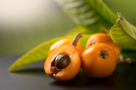 Medlar, Loquat fruit or Japanese medlars, Nispero, Eriobotrya japonica with leaves fresh ripe bio vegetarian food, medlar berries. Close up.の写真素材