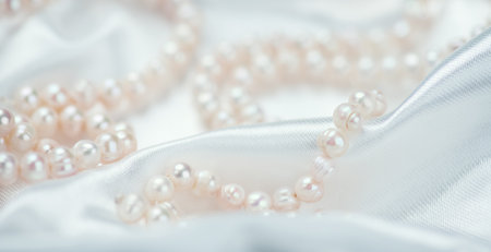 Pearl necklace over white silk background, close up. Beautiful Natural pearls beads, elegant accessories. Wedding concept, Valentine's Day Giftの写真素材