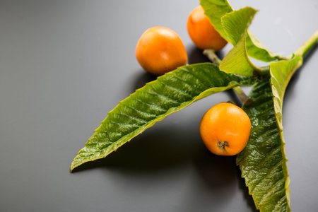Loquat fruit or Japanese medlars, Nispero, Eriobotrya japonica with leaves fresh ripe bio vegetarian...