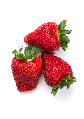 Strawberry isolated on white background. Three Fresh ripe organic strawberries, macro shot of fresh juicy berries, top view, close up, flat layの写真素材