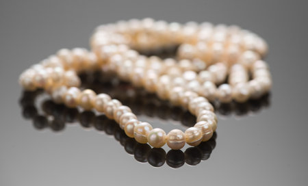 Pearl necklace over black background, close up. Beautiful Natural pearls beads, elegant accessories macro shot. Pearl gemstones, glamourの写真素材