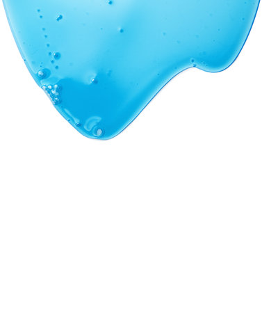 Blue liquid gel flowing, washing, shower fluid gel border, isolated on white background, dripping shampoo texture on white, body care cosmetic, texture of liquid gel, soap backdropの写真素材