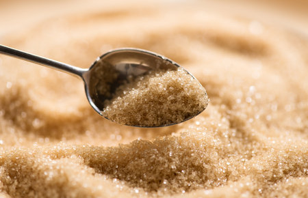 Brown Cane sugar in a spoon close up. Healthy eating, diet concept, macro shot, closeupの写真素材