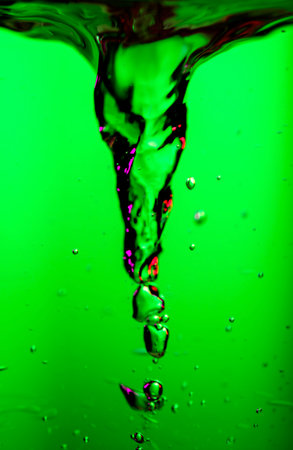 Water swirl storm twister, underwater vortex on green background, whirlpool, storm tornado twister typhoon vortex in a fresh water, spin, splash with bubbles, vertical shotの写真素材
