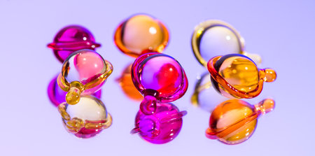 Cosmetic capsules for face or hair care, colorful liquid-filled capsules, oil, serum, pink and yellow varieties, glossy, reflective surface. Capsules background, vibrant, modern aeの写真素材