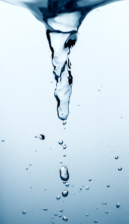 Water swirl storm twister, underwater vortex, whirlpool on blue background, storm tornado twister typhoon vortex in a fresh water, spin, splash with bubbles, vertical imageの写真素材