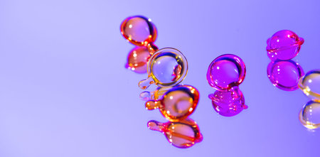 Cosmetic capsules, hair care oils, colorful liquid-filled capsules, oil, serum, pink and yellow...