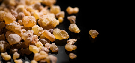 Frankincense olibanum resin, Boswellia sacra Isolated on black background. Frankincense or olibanum aromatic resin using in incense and perfumes, medicine, religion concept. Incensの写真素材