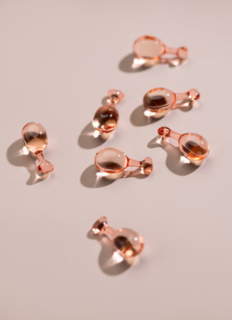 Skin care face serum, revitalising capsules for youthful skin, collagen Professional cosmetics. Face care, pink liquid-filled capsules. Beauty treatment. Top view, flat lay.の写真素材