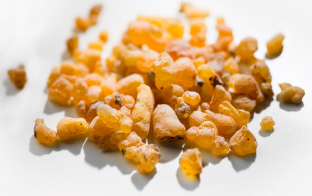 Frankincense olibanum resin, Boswellia sacra Isolated on white background. Frankincense or olibanum aromatic resin used in incense and perfumes, border design, macro shotの写真素材
