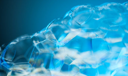 Foam texture close up, border design on blue background. Liquid soap bubbles, Soap. Foam bubbles...