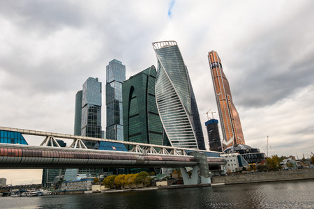 MOSCOW, RUSSIA - OCTOBER 24, 2017: Pedestrian two-level "Bagration" Bridge over the Moscow river on the background of Moscow International Business Centre MIBC.のeditorial素材