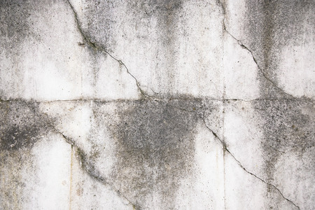 Close-up of rough texture of aged gray concrete wall with geometric pattern relief, with dirty flow marks.の写真素材