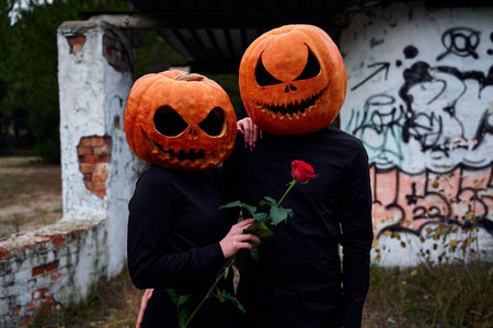 Halloween boy and girl with pumpkins on their headsの写真素材