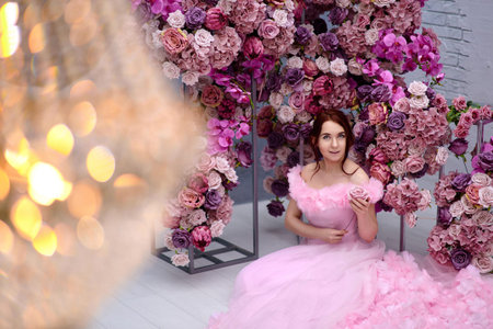 Girl in red with a roseの写真素材