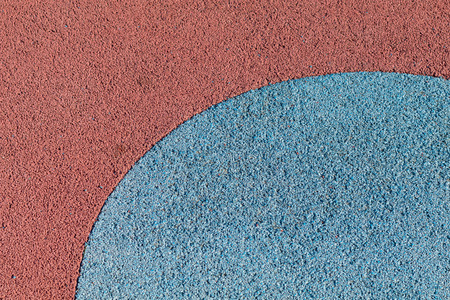 Rubber play ground floor surface covering, colorful blue and red, curved shapesの写真素材