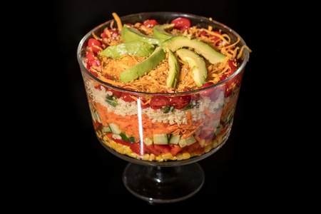 Multi Layered Salad in a Glass Trifle Bowl on black backgroundの写真素材