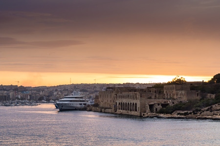 Beautiful colorful sunset over Manoel Island, looking towards Misda, shot from Marsamxett Harbour, Malta.の写真素材