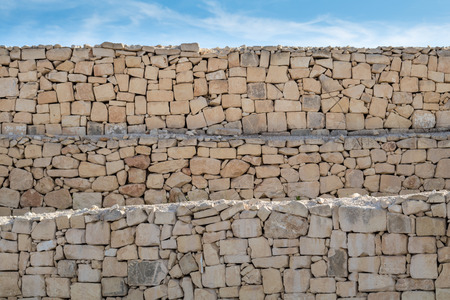 Rubble wall under blue skyの写真素材