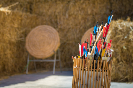Quiver of traditional feathered arrows in front of traditional ancient medieval straw practice archery targets, Medieval Mdinaの写真素材